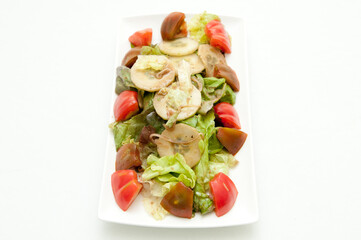 Wall Mural - High angle shot of a plate of a healthy delicious salad on a white background