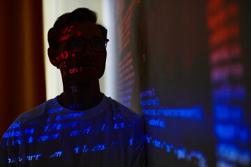 it manager standing near the white board and presenting new computer program in dark office