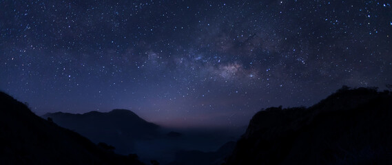milky way galaxy at night. image contains noise and grain due to high iso. image also contains soft 