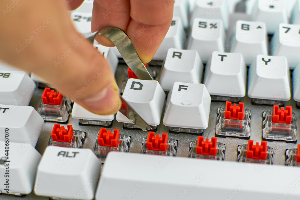 Person cleans a computer keyboard. Cleaning of computer equipment ...