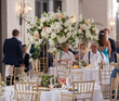 Beautiful decorations at indoor wedding reception with people out of focus in background