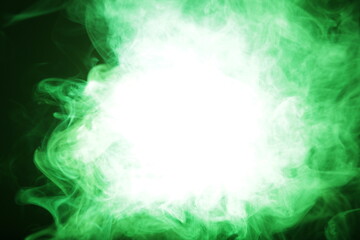 Poster - Artificial magic smoke in green light on black background