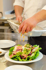 Sticker - Vertical shot of chef preparing green salad in the kitchen