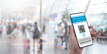 Traveler shows health passport of vaccination certification on mobile phone via mobile app at international airport, to certify that have been vaccinated of coronavirus covid-19, vaccine passport