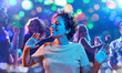 © Syda Productions - celebration and nightlife concept - happy smiling young african american woman dancing at christmas or new year party in ultraviolet neon lights over nightclub background