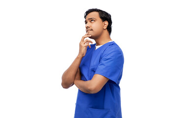 healthcare, profession and medicine concept - thinking indian doctor or male nurse in blue uniform over white background
