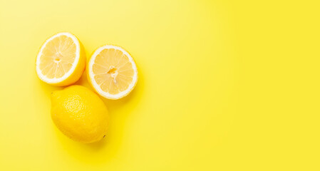 Wall Mural - Fresh ripe lemons on yellow background