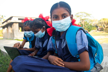 indian village government school girls Wearing mask using laptop