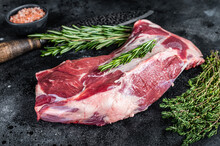 Fresh Raw Lamb Or Goat Shoulder Meat With Butcher Knife. Black Background. Top View