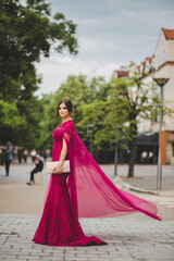 Canvas Print - Vertical shot of gorgeous Caucasian female with long pink dress posing outdoor