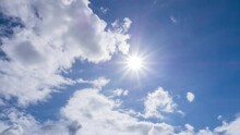 Beautiful Fluffy White  Cumulus Clouds In Blue Sky Summer Season. Dramatic Cloud Covered Bright Sun Star In Clear Good Atmosphere, Cloudscape Time-lapse Of Powerful  Sunlight Beam, Rays In Midday, 