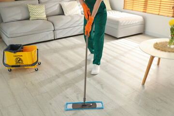 Poster - Woman cleaning floor with mop at home, closeup