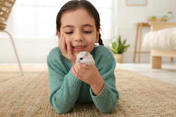 Sticker - Little girl with cute hamster at home