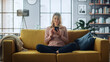© Gorodenkoff - Beautiful Caucasian Female Using Smartphone in Stylish Living Room while Sitting on a Cozy Couch Sofa. Young Woman Resting at Home, Browsing Internet, Using Social Networks, Having Fun in Flat.
