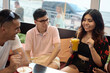 © etonastenka - Multiracial happy young people drink coffee at cafe, black and white cheerful mates laughing enjoying drinks having fun sitting together at restaurant table, diverse friends share lunch at meeting