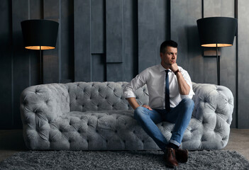 Wall Mural - Handsome businessman on sofa indoors. Luxury lifestyle