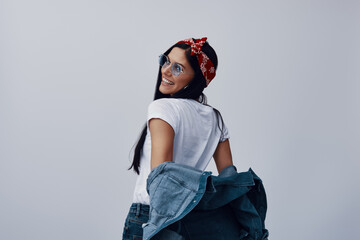 Wall Mural - Fashionable young woman in bandana looking away and smiling