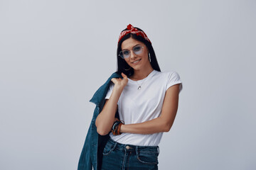 Wall Mural - Attractive young woman in bandana looking at camera and smiling