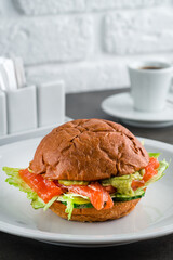 Wall Mural - Healthy Salmon Burger with Avocado served