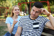 © New Africa - Displeased man ignoring overtalkative young woman during first date in park