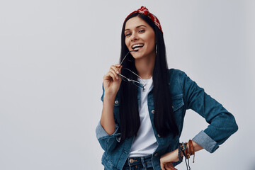 Wall Mural - Attractive young woman in bandana looking at camera and smiling