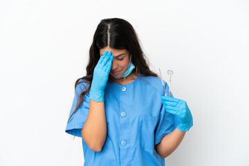 Dentist woman holding tools over isolated white background with tired and sick expression