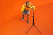 © shunevich - Exited young afro american fitness sport trainer hold online lesson on mobile phone on tripod during quarantine pandemic, giving motivation to student through video camera distantly