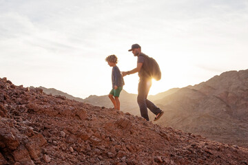 Wall Mural - Dad with son in the mountains in the desert