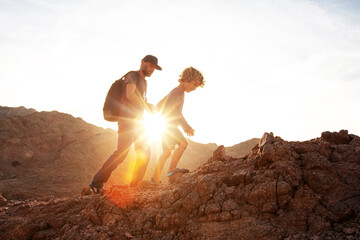 Wall Mural - Dad with son in the mountains in the desert