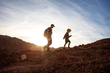 Wall Mural - Dad with son in the mountains in the desert