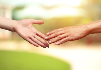 Wall Mural - Concept of human relation. Hand of male and female reaching to each other.