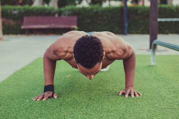 Young fitness man training outside outdoors