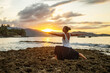 © Maygutyak - Woman doing yoga by the sea