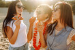 © maxbelchenko - Three young girlfriends having fun on the beach and eating pizza. Fast food concept. Summer vacation, holidays, travel, lifestyle  and people concept