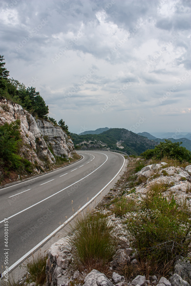 Big empty road with left turn in a mountains Stock Photo | Adobe Stock