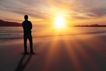 Man relaxing on the beautiful beach at sunset.