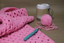 Closeup Shot Of A Pink String In A Crochet Pattern And Tools