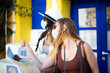 © Fabio Balbi - Two girl friends standing in the city looking at a tourist map and wearing face masks