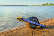 One-wheeled Electric Skateboard (personal Transporter) On A Lake Shore In Colorado
