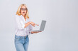 © denis_vermenko - Photo of amazed shocked surprised senior mature old woman holding laptop computer isolated on white grey background.