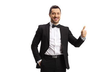 Wall Mural - Elegant man in a suit and bow showing thumbs up