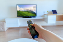 TV Remote Control In Hand To Switch Channels Close Up