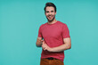 © gstockstudio - Handsome young man in casual clothing looking at camera and smiling while standing against blue background