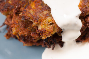 Sticker - Closeup shot of vegetable latkes or pancakes with sour cream yogurt