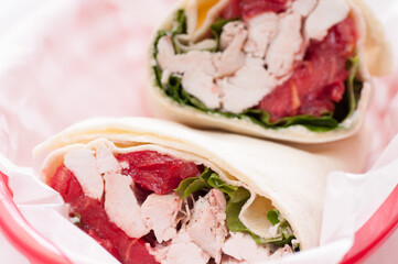 Canvas Print - Closeup shot of stuffed pita with chicken meat, tomato, and lettuce