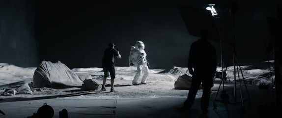 Wall Mural - wide behind the scenes, cinematographer shooting viral video for social account on a large moon land
