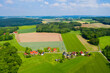 Aerial view from the drone of landscape of the German countryside. Agricultural fields, villages, and woodlands.