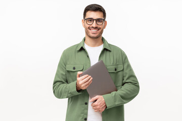 Young smiling modern male teacher holding laptop, isolated on gray background