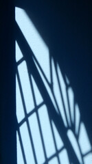 Poster - shadow of window on blue wall with sunlight