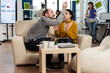 © DC Studio - Business colleagues arguing, yealing each other during work hours sitting on the couch, while diverse colleagues working scared in background. Coworkers having conflict because of mistakes from